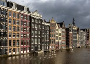 Canal houses on the Damrak in Amsterdam