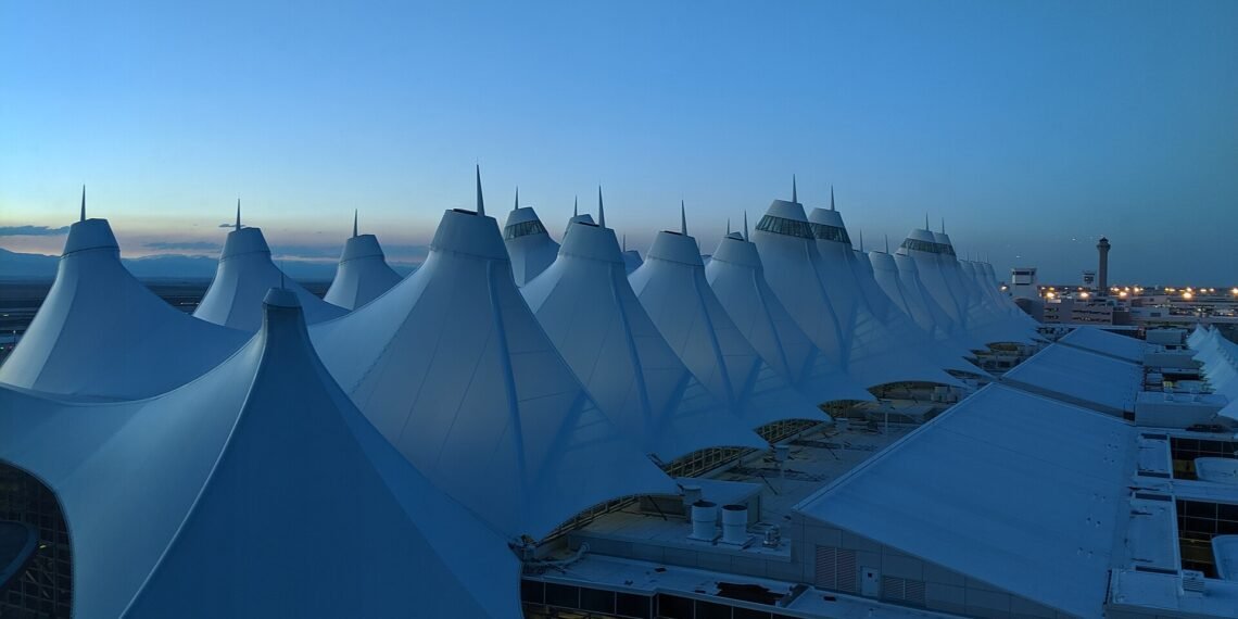 Denver International Airport main terminal with its peaked roof at dusk