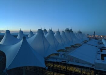 Denver International Airport main terminal with its peaked roof at dusk