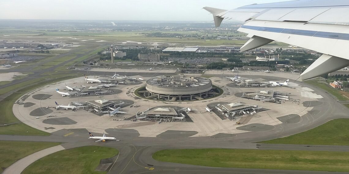 Aerial view of the circular Terminal 1 at Paris Charles de Gaulle Airport, seen from an aircraft window