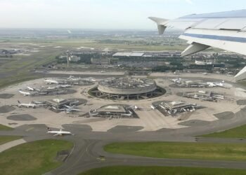 Aerial view of the circular Terminal 1 at Paris Charles de Gaulle Airport, seen from an aircraft window