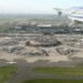 Aerial view of the circular Terminal 1 at Paris Charles de Gaulle Airport, seen from an aircraft window