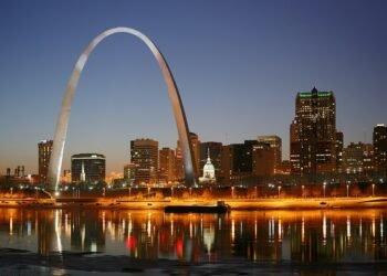 St. Louis skyline at night on the Mississippi River, with the Gateway Arch and the Old Courthouse